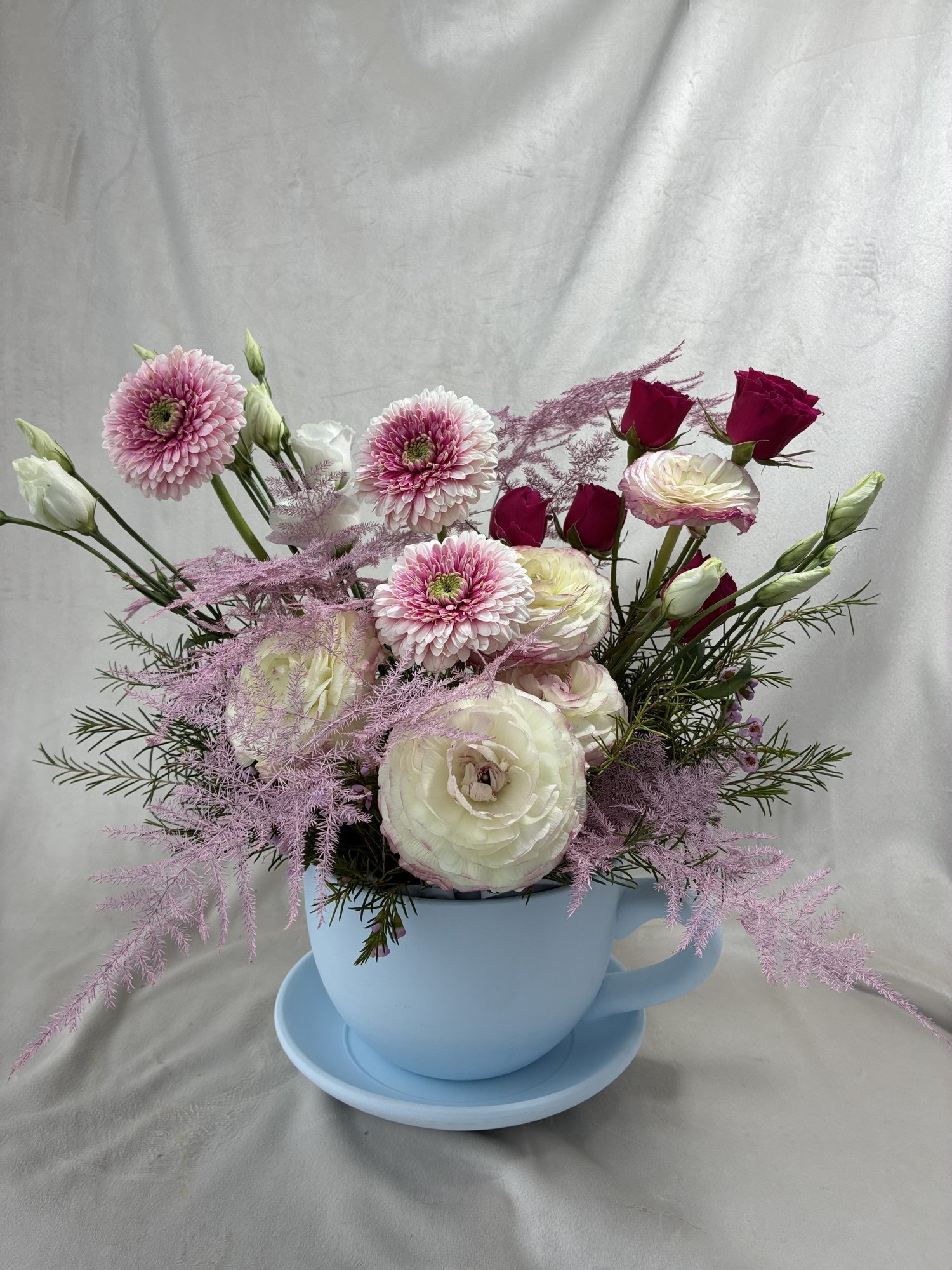 Aranjament Floral în Ceașcă Albastră – Ranunculus, Gerbera și Trandafiri | Cadou Elegant Premium